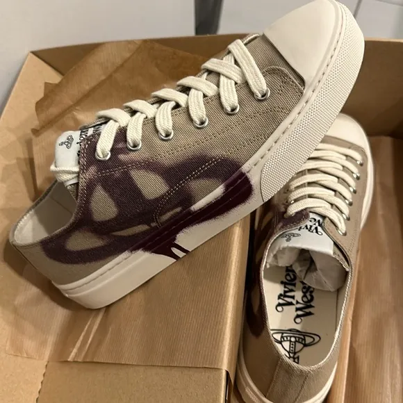 Vivienne Westwood designer sneakers are size 7. Beige with a purple design.