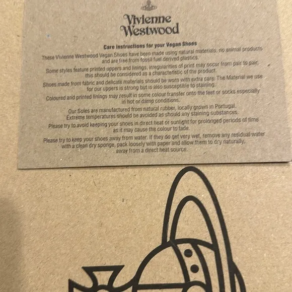 Vivienne Westwood designer sneakers are size 7. Beige with a purple design.