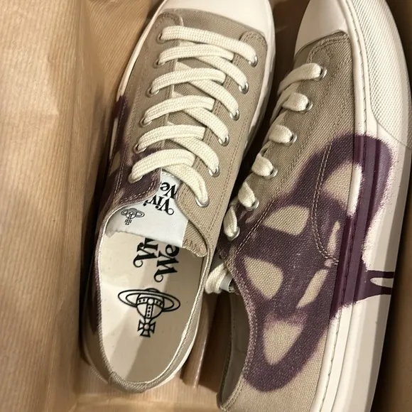 Vivienne Westwood designer sneakers are size 7. Beige with a purple design.