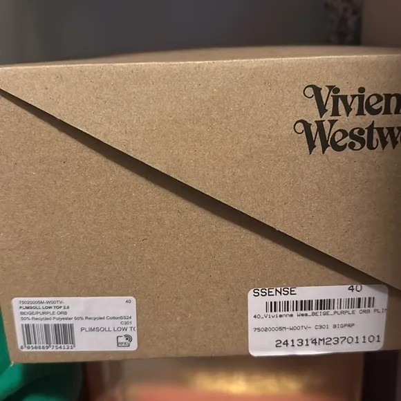 Vivienne Westwood designer sneakers are size 7. Beige with a purple design.