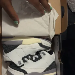 White and Gray Low-Top Sneakers with Eye-Catching Design